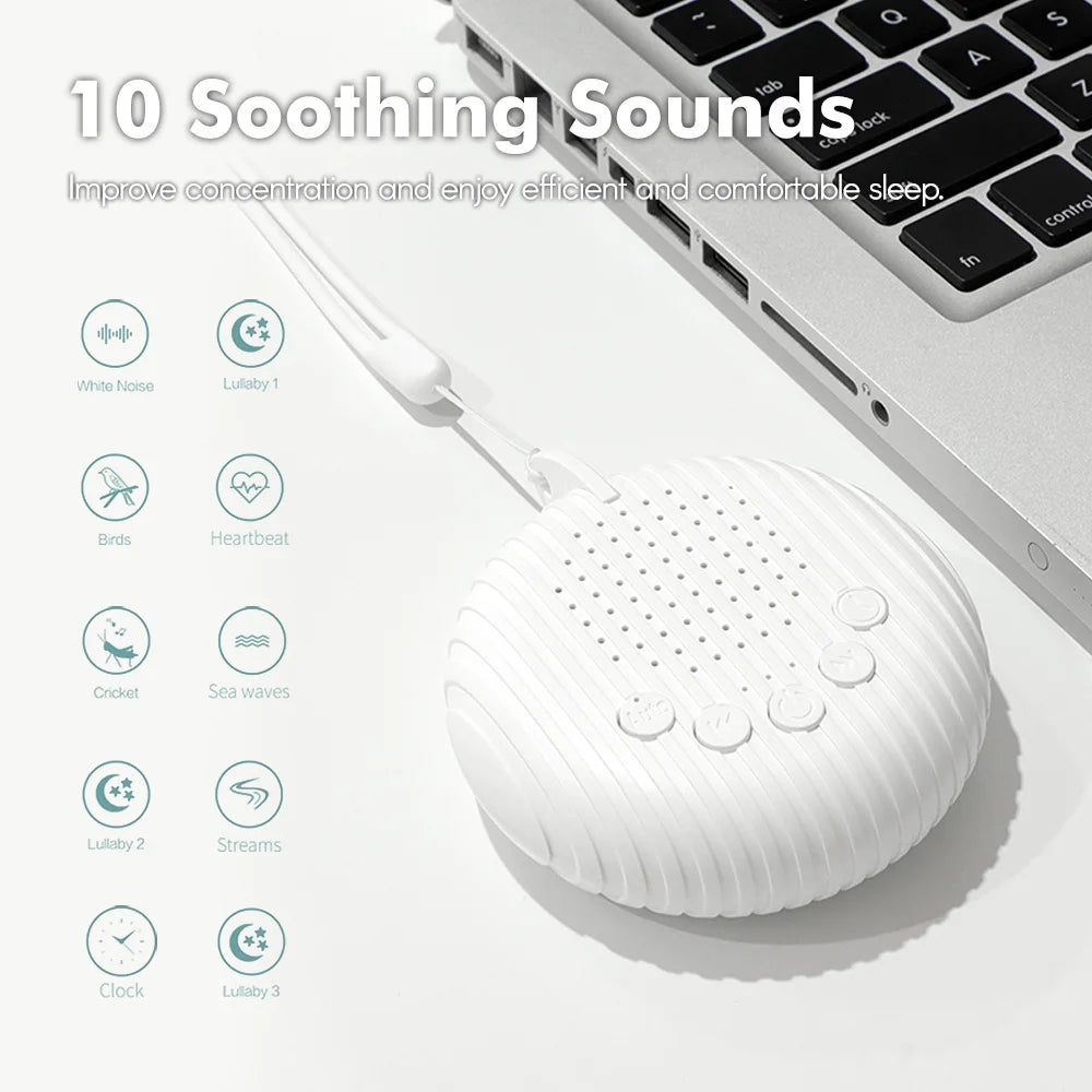 White noise machine next to a laptop on a desk